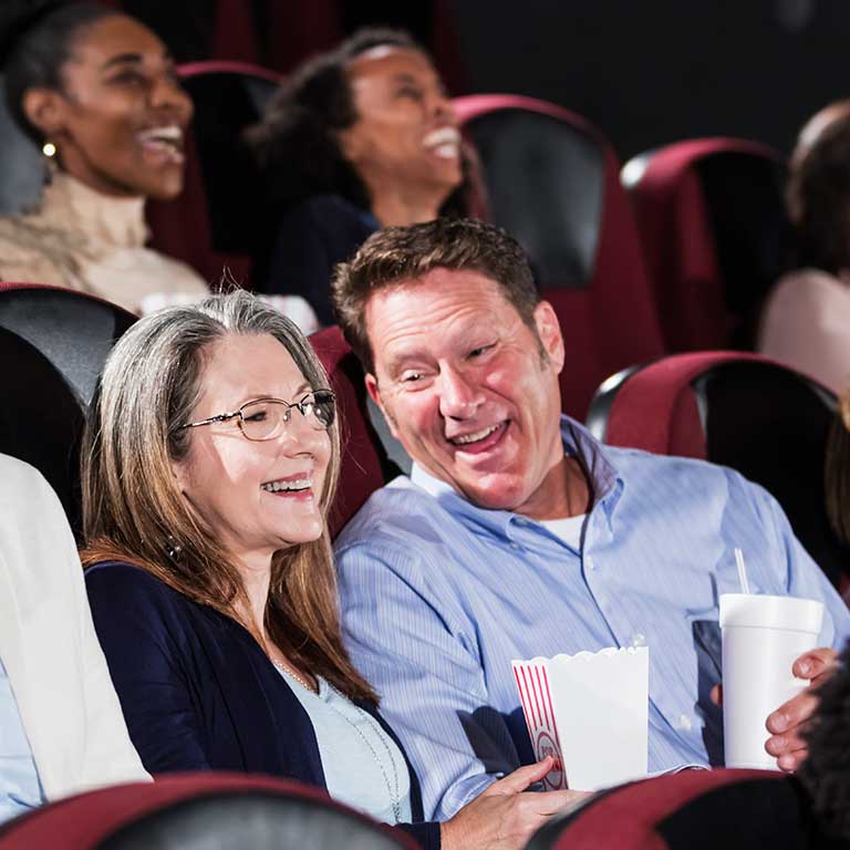 Couple at a noisy movie theater