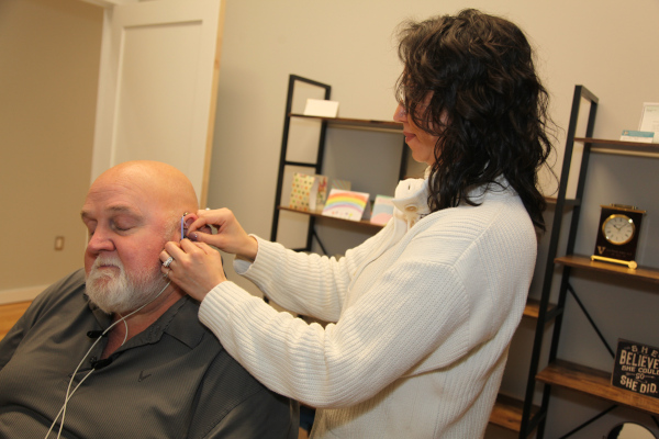 Dr. Angley fits a patient with a hearing aid using Real Ear Measurement